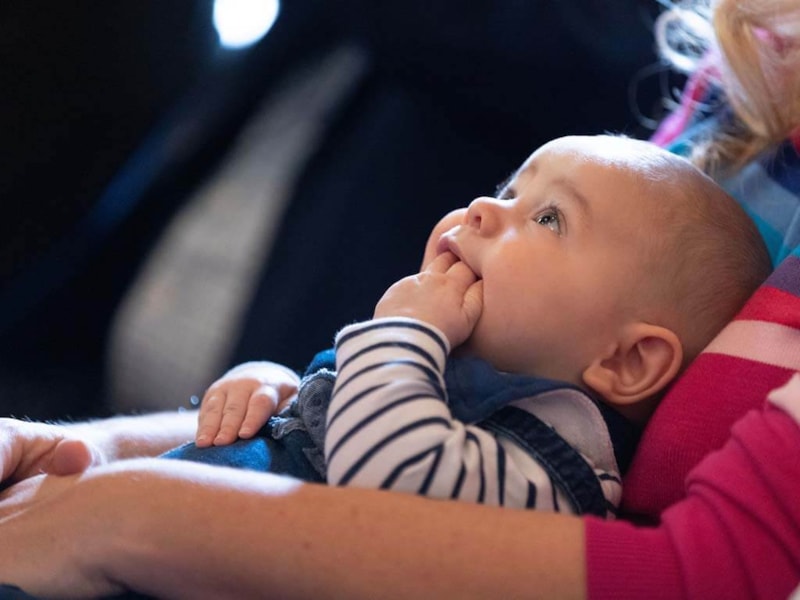 Baby being held in arms